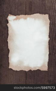 Empty aged paper on the wooden background. aged paper on wood