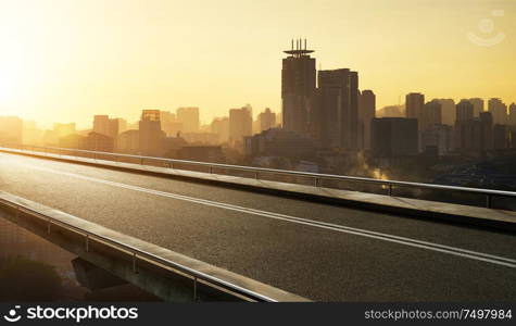 Empty asphalt flyover road with modern cityscape skyline , sunset scene .