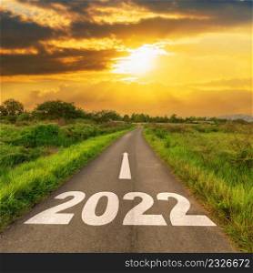 Empty asphalt road and New year 2022 concept. Driving on an empty road to Goals 2022 with sunset.