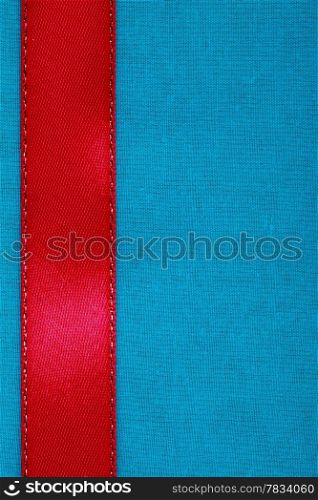 Empty banner on blue background. Red ribbon on fabric cloth texture with copy space.