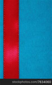 Empty banner on blue background. Red ribbon on fabric cloth texture with copy space.