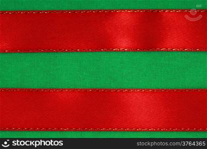 Empty banner on textile background. Red ribbon on green fabric cloth texture with copy space.
