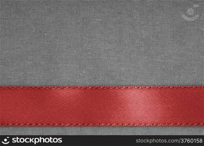Empty banner on vintage background. Red ribbon on gray fabric cloth texture with copy space.