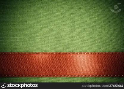 Empty banner on vintage background. Red ribbon on green fabric cloth texture with copy space.