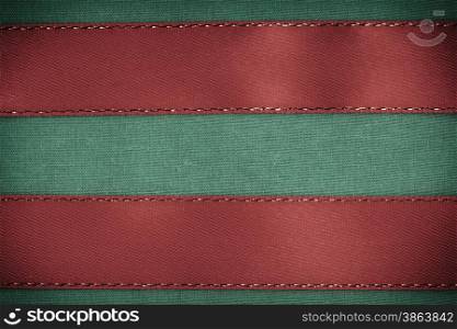 Empty banner on vintage background. Red ribbon on green fabric cloth texture with copy space.