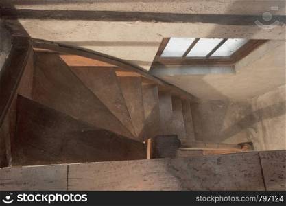 empty basement in abandoned old industrial building with little light and a wooden stairs darkness. empty basement in abandoned old industrial building with little light and a wooden stairs