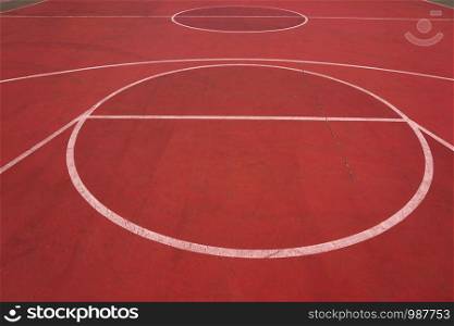 empty basketball court with white lines on the street