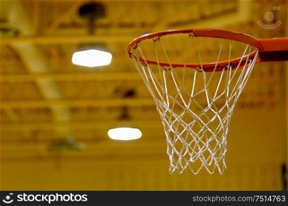 Empty basketball net in gymnasium