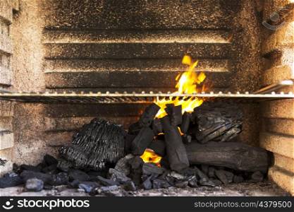 empty bbq grill pit with hot charcoal briquettes