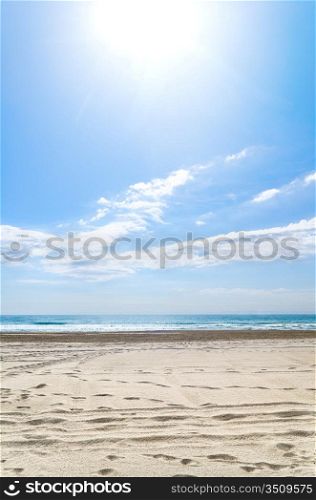 empty beach at sunny day with footprints, Spain