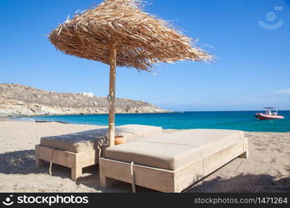 empty beach chairs and umbrella