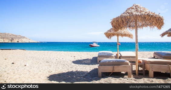 empty beach chairs and umbrella