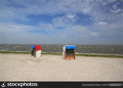 empty beach chairs on a sunny but cool day at the german north sea coast. empty beach chairs