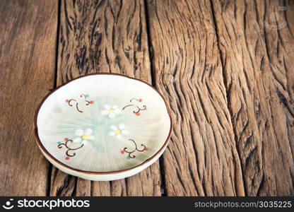 Empty beautiful japanese dish on a wooden table background.