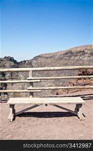 Empty bench in front of volcano Vesuvius crater. This bench is used during trekking