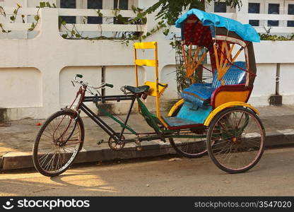 Empty bicycle rickshaw in street. Pondicherry, South India