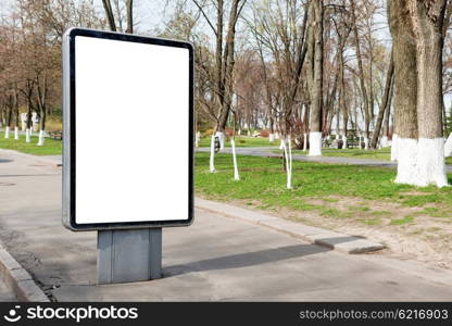 Empty billboard or lightbox on green city street with white isolated background