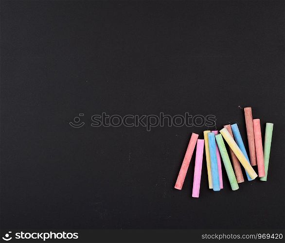 empty black chalk board and colorful chalk, full frame, copy space