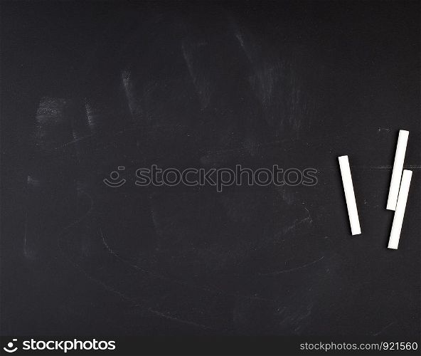 empty black chalk board and white chalk, full frame, copy space