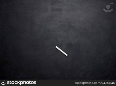 Empty black chalk board and white chalk stick