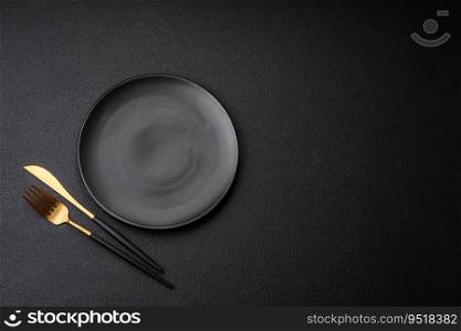 Empty black plate over dark stone background with copy space. Top view