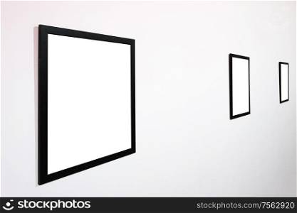 Empty blank picture wooden frame in interior on white wall