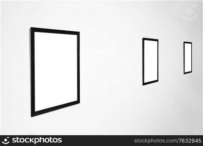 Empty blank picture wooden frame in interior on white wall