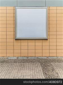 Empty blank square white advertising billboard on orange tiled wall. Information. Promotion of your product. Real.