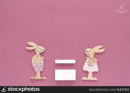 Empty blank wooden cubes calendar Mock up tamplate for your calendar date. Pair of rabbits, wooden figures on pink paper background Copy space Creative Top view Flat lay Top-down composition.. Empty blank wooden cubes calendar Mock up tamplate for your calendar date. Pair of rabbits wooden figures on pink paper background Copy space Creative Top view Flat lay Top-down composition