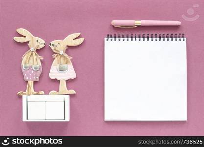 Empty blank wooden cubes calendar Mock up tamplate for your calendar date. Pair of rabbits, wooden figures notepad on pink paper background Copy space Creative Top view Flat lay Top-down composition.. Empty blank wooden cubes calendar Mock up tamplate for your calendar date. Pair of rabbits wooden figures notepad on pink paper background Copy space Creative Top view Flat lay Top-down composition
