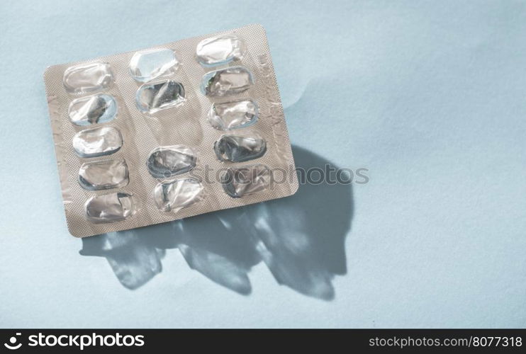 Empty blister pack drugs on blue background