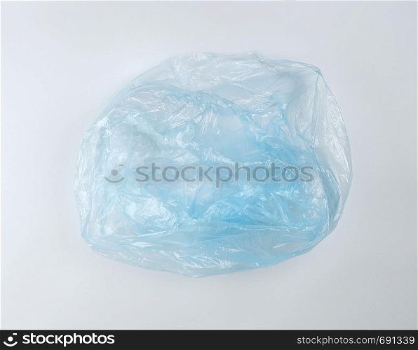 empty blue plastic bag for garbage on a white background, top view