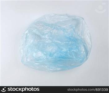 empty blue plastic bag for garbage on a white background, top view