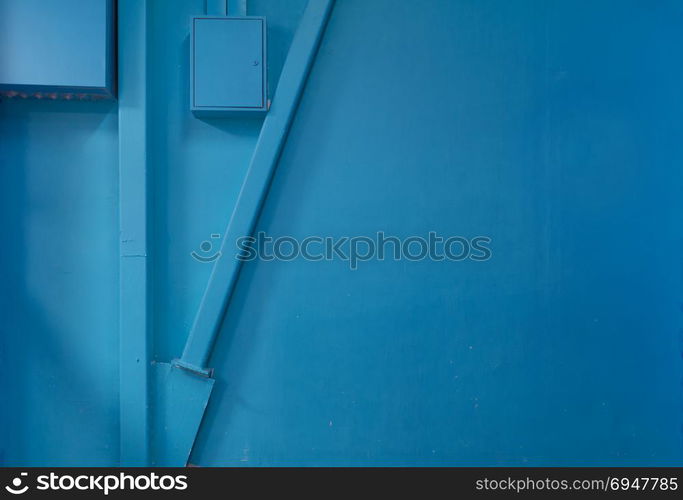 Empty blue wall with some construction elements, industrial background. Empty blue wall with some construction elements, industrial background.