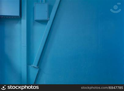 Empty blue wall with some construction elements, industrial background. Empty blue wall with some construction elements, industrial background.