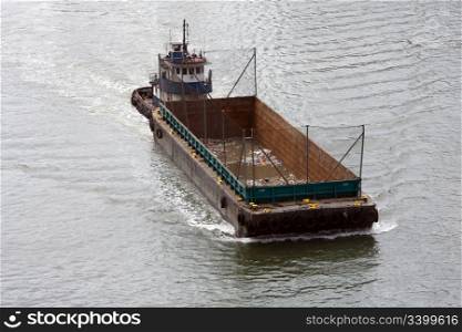 Empty boat for transporting garbage cruising in a river, used for waste management