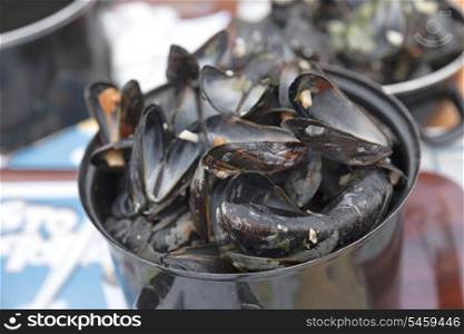 Empty boiled mussels in the pot on table, selective focus&#xA;