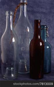 Empty bottles isolated on painted background
