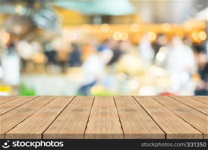 Empty brown wood table top on blurred background at coffee shop, copy space for montage your product