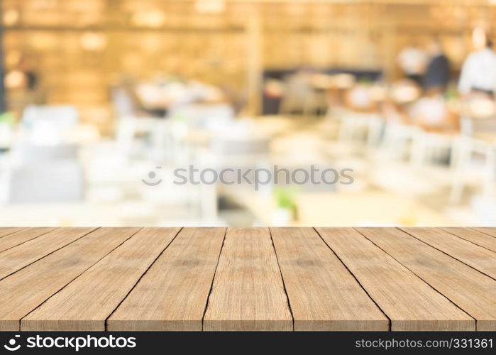 Empty brown wood table top on blurred background at coffee shop, copy space for montage your product