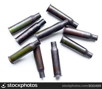 Empty bullet shells on a white background. A pile bullet shells on a white background