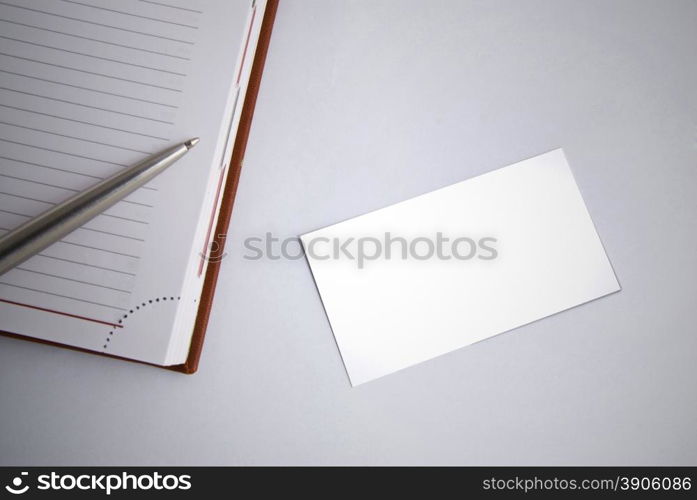 Empty business card with diary and pen