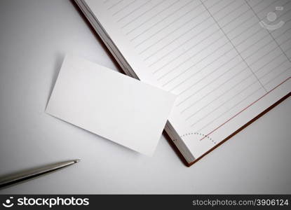 Empty business card with diary and pen