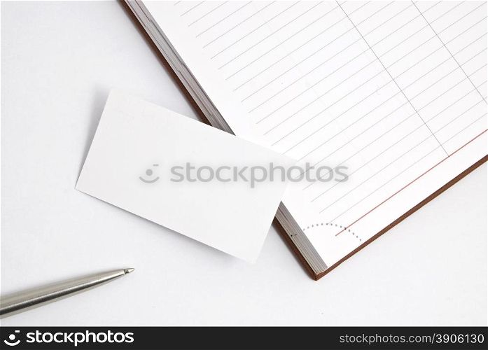 Empty business card with diary and pen isolated on white