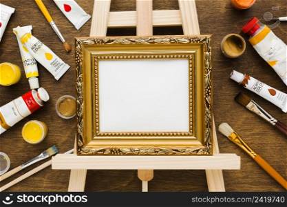 empty canvas golden frame paint flat lay