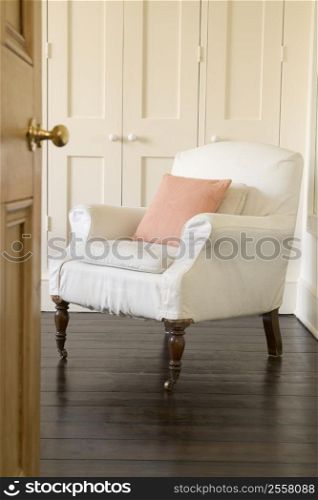 Empty chair shot through doorway
