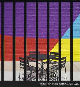 Empty chairs and table arranged on sidewalk cafe seen through metal fence, Minneapolis, Hennepin County, Minnesota, USA