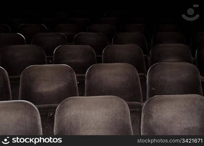 Empty chairs at cinema or theater. Gray toned