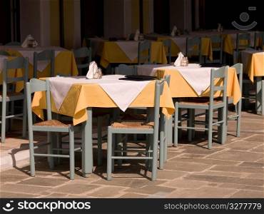Empty chairs at ourdoor cafT in Katakolon