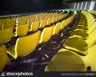 Empty chairs in the stands of the movie theater. Many empty seats for spectators. 
